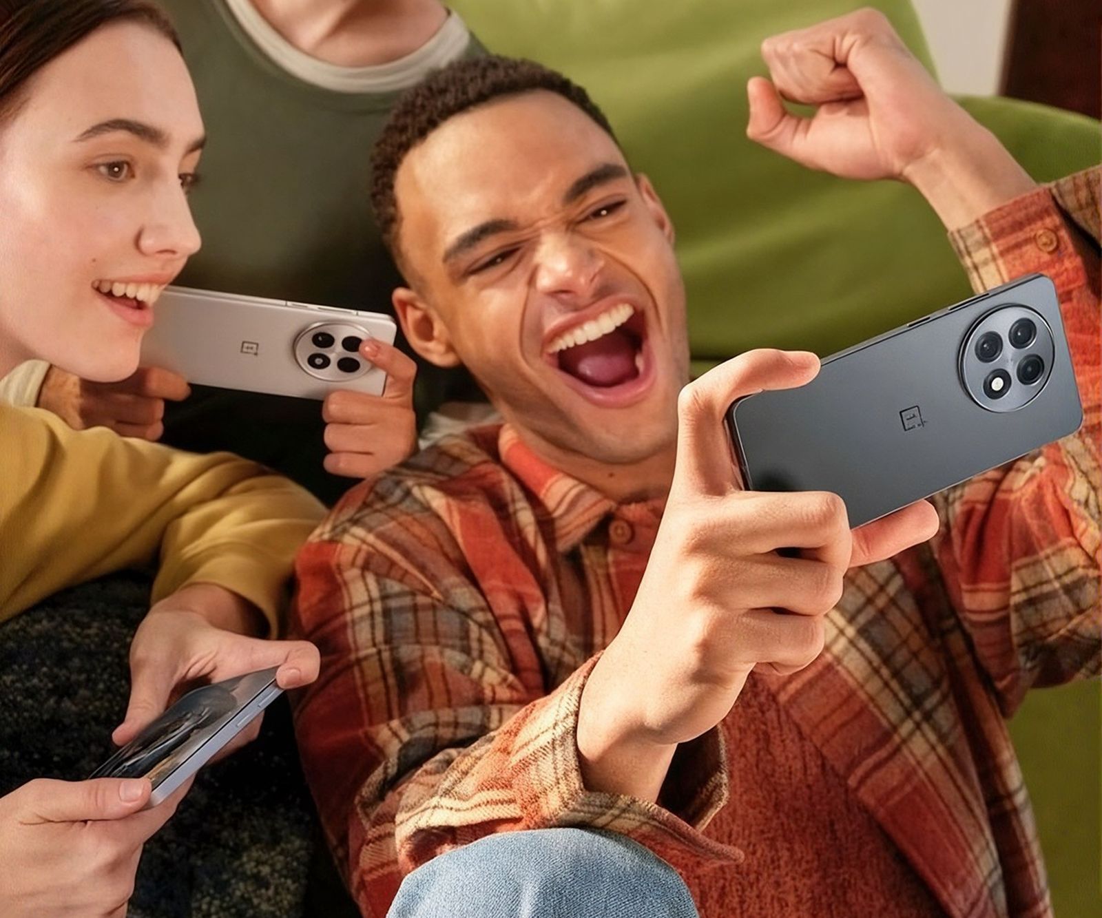 Friends cheering while playing on their phones